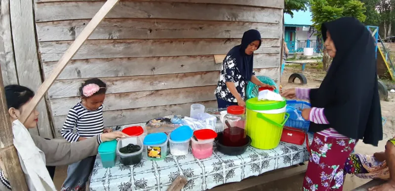 Nur Hayati saat melayani penjual yang sedang memesan es buah yang didalamnya di campur dengan Cincau.