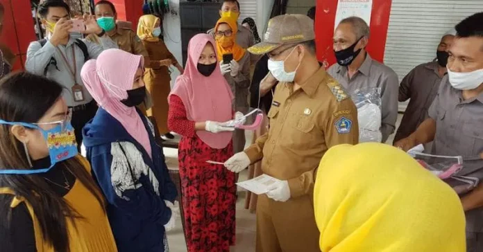 Menuju New Normal, Pemkot Kendari Bagikan Pelindung Wajah ke Pedagang Pasar