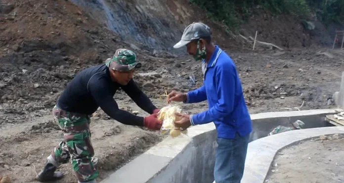 koltim tmmd Pedagang Sayur Bagikan Makanan Ringan ke Anggota Satgas TMMD di Koltim